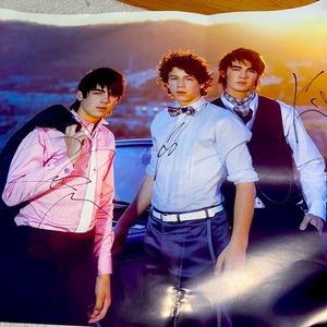Signed Jonas brothers poster with some bends that can easily be fine when framed